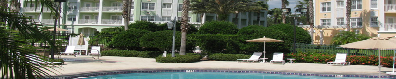 Resort pool area with tropical buildings in pastel colors
